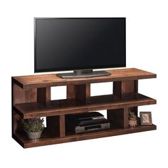 an entertainment center with a flat screen tv mounted on it's side and shelves