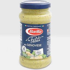 a jar of pesto sauce on a white surface