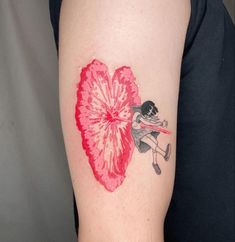 a woman's arm with a heart shaped flower tattoo on the left side of her body