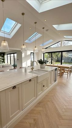 a large kitchen with an island and skylights