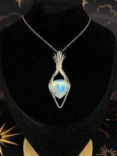 Gorgeous Moonstone with beautiful blue and yellow flash wrapped in Oxidized Sterling silver wire.  I can send it on a chain or a black nylon cord that is adjustable. Silver Adjustable Teardrop Crystal Necklaces, Silver Adjustable Teardrop Crystal Necklace, Adjustable Wire Wrapped Crystal Necklace With Round Pendant, Handmade Adjustable Sterling Silver Crystal Necklaces, Adjustable Hand Wrapped Mystical Necklace, Unique Hand Wrapped Silver Plated Wire Necklace, Iridescent Adjustable Mystical Jewelry, Mystical Silver Wire Wrapped Necklace, Silver Teardrop Wire Wrapped Crystal Necklaces