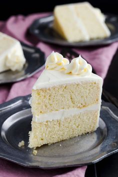 a slice of white cake on a black plate