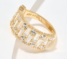 An eye-catching combination of round- and baguette-cut stones gives this ring a distinctive (and dazzling!) look. Luxury Baguette Cut Ring For Party, Glamorous Sparkling Crystal Ring, Elegant Round Cut Crystal Ring For Party, Glamorous Open Crystal Ring, Cubic Zirconia Baguette Cut Party Rings, Cubic Zirconia Baguette Cut Ring For Parties, Party Rings With Baguette Cut Cubic Zirconia, Modern Crystal Ring With Cubic Zirconia, Glamorous Round Crystal Ring For Parties