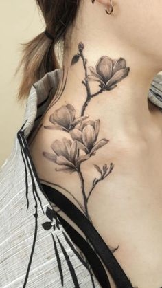 a woman with a flower tattoo on her neck