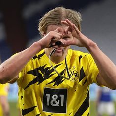 a soccer player covers his eyes with his hands