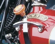 a close up view of the handlebars on a red motorcycle