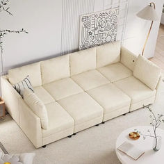 a living room with a white couch and coffee table