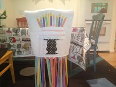 a chair that has been decorated with different colored ribbons on the back of it,