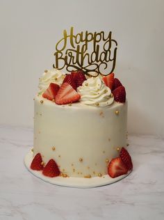 a birthday cake with strawberries on top