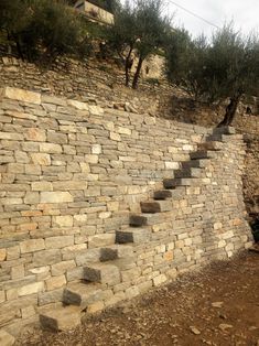 a stone wall with steps going up it