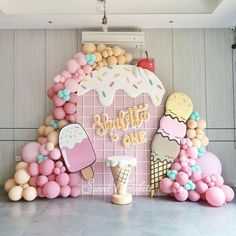 an ice cream themed birthday party with balloons and decorations on the wall, including popsicles