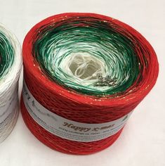 two spools of yarn sitting next to each other on top of a white surface