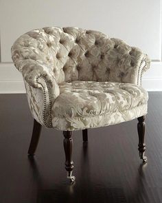 a chair sitting on top of a hard wood floor next to a white painted wall