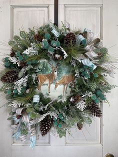 a christmas wreath with deer and pine cones