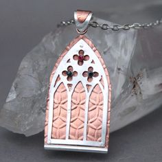 "Gothic Window" - One of my favorite styles is intricate Gothic architecture - I never get tired of admiring their windows! I created this piece to capture the beautiful architecture into wearable art. A Ruby and two Sapphires are set in the clover panels, with a matching sterling and copper bail to finish the piece. Crafted from copper, sterling silver, Ruby and Sapphire. The pendant measures 5 cm by 3 cm. The pendant comes with a 20" sterling-plated chain. If you require a longer, shorter or d Windows Aesthetic, Rose Project, Architecture Elements, Gothic Window, Gothic Windows, Gothic Pendant, Pin Ideas, Silver Clay, Gothic Architecture