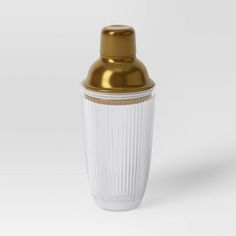 a white and gold vase sitting on top of a table