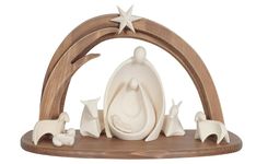 a nativity figurine is displayed on a wooden stand with an arch and stars