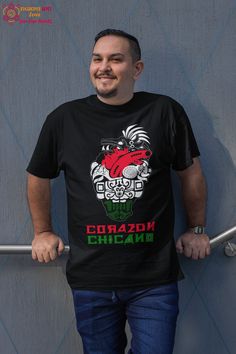 Celebrate Chicano pride and Mexican heritage with our Aztec Art Print Chicano Pride Shirt--a unique expression of cultural pride and artistic flair. This t-shirt features a vivid Aztec design that showcases traditional Mexican art while making a bold statement about identity and heritage. Crafted from 100% combed ringspun cotton, this shirt offers a premium fit and ultra-soft feel, ensuring all-day comfort. The light fabric (4.2 oz/yd²) provides a durable and breathable experience, perfect for c Traditional Short Sleeve Shirt With Graphic Print, Traditional Short Sleeve T-shirt With Graphic Print, Traditional T-shirt With Graphic Print And Short Sleeves, Traditional Short Sleeve Graphic Print T-shirt, Mexican Shirts For Men, Traditional Mexican Art, Mexican Clothing, Mexican Shirt, Mexican T Shirts