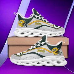 a pair of green bay packers sneakers on top of a cardboard box with purple background