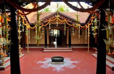 an outdoor area decorated in orange and white with decorations on the floor, pillars and ceiling