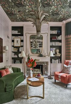 a living room filled with furniture and a chandelier above a fire place in front of a fireplace