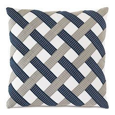 a blue and white pillow on a white background