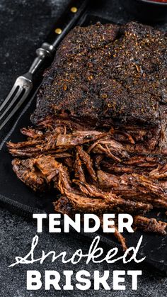 tender smothered brisket on a black plate with fork and knife next to it