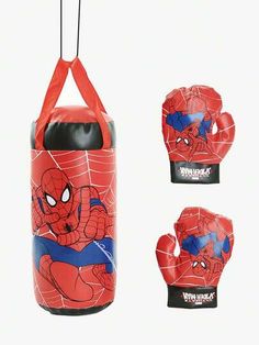 the spiderman boxing gloves are red with blue and white designs on them, along with an orange punching bag