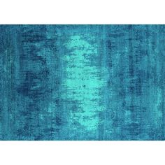 a blue rug with an abstract design on the bottom and sides, in shades of teal