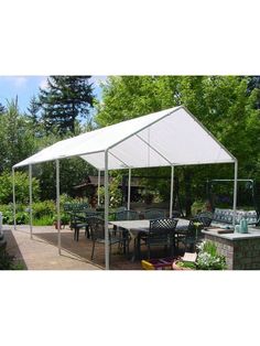 a large white tent sitting on top of a patio next to a table and chairs