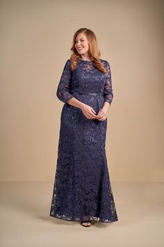 a woman in a long blue lace dress