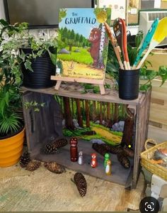 there are many plants and books on this shelf