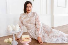 The Naples Dress combines a subtle nude base with a delicate, white floral lace overlay for a sophisticated and feminine look. With a high neckline, sheer long sleeves adorned with pearl bead cuffs and a midi length, this dress exudes elegance. A hidden back zipper and full lining ensure a comfortable and smooth fit. Available in sizes 00, 0, 2, 4, 6, 8, 10, 12, 14, 16, 16W, 18W, 20W, 22W, 24W, 26W, 28W, 30W, 32W, + 34W!! plus size, lace, white lace dress, valentines day, long sleeve dress Cream Lace Long Sleeve Midi Dress, Beige Long Sleeve Lace Midi Dress, Elegant Midi Dress With Lace Collar For Wedding, Wedding Midi Dress With Sheer Sleeves, Long Sleeve Lace Sleeve Midi Dress For Wedding, Long Sleeve Midi Dress With Lace Sleeves For Wedding, White Long Sleeve Lace Dress For Wedding Guest, Long Sleeve Midi Dress With Sheer Sleeves For Wedding, Cream Long Sleeve Midi Dress With Lace Trim