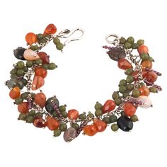 Multi hued gemstones including Tourmaline, Carnelian, Garnet and Apatite are threaded onto sterling silver wire and attached to silver chain with a handmade clasp. A wonderful mix of Fall colors in Oranges, Reds and Greens. Gemstone beads are mixed by color, shape, and size for an energetic, unique feel. A wonderful way to get the chunky bracelet jewelry trend with a playful pile of gemstones. This beaded bangle will add a bit of charm to your outfit. - Tourmaline, Garnets, Apatite, Carnelian -