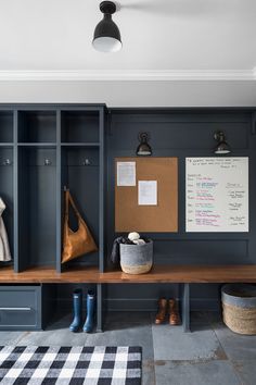 a wooden bench sitting in front of a locker with shoes on top of it and a cork board attached to the wall