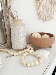 a white table topped with shells and a vase