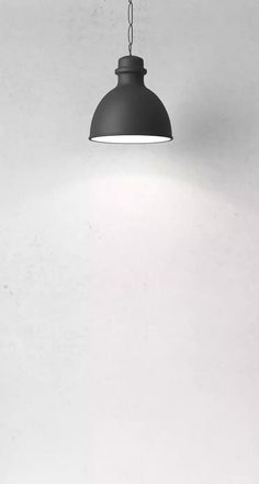 a black and white photo of a light hanging from a ceiling fixture in a room