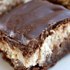 two pieces of chocolate covered dessert on a plate