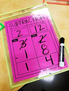 a subtraction activity for kids with numbers and letters on the pink sheet, next to a marker