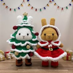 two stuffed animals dressed up as christmas trees