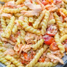 pasta salad with chicken and tomatoes in a bowl