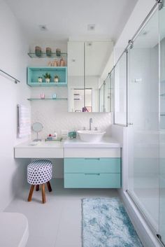 a bathroom with blue and white decor on the walls