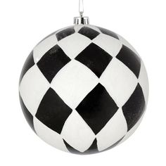 a black and white christmas ornament hanging from a chain