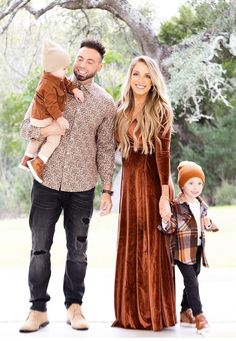 a man and woman are holding two children