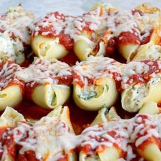 pasta shells covered in marinara sauce and parmesan cheese