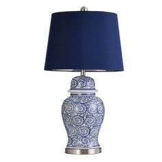 a blue and white vase lamp with a blue shade on it's base is shown