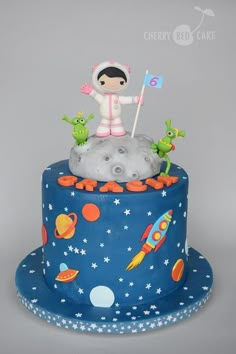 a birthday cake with an astronaut on top