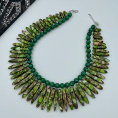 "PLEASE NOTE: The color may be slightly different from the pictures on different devices. This beautiful Green Yellow Jasper and Malachite Statement Necklace is completely handmade with high quality. Matching earrings are available. This gorgeous Jasper Statement Necklace goes with everything and everywhere, holiday party or after work with friends. Necklace made from green malachite round beads 10 mm, and green yellow graduated jasper 18~46 x 4~8 x 6~9 mm. The Necklace length is 16.5\" short la Green Beaded Necklace With Natural Stones, Green Malachite Beaded Necklaces With Natural Stones, Green Malachite Beaded Necklace With Natural Stones, Handmade Green Malachite Beaded Necklace, Unique Green Beads With Natural Stones, Green Beaded Necklace With Faceted Beads, Adjustable Green Malachite Beaded Necklace, Adjustable Green Malachite Beaded Necklaces, Friends Necklace