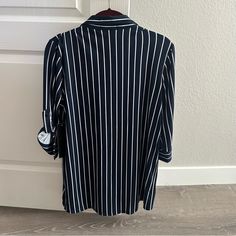 Brand New Navy Blue Shirt With White Vertical Stripes. Has Two Functional Pockets On The Front And 3/4 Cuffed Sleeves. Lightweight And Very Soft Material. 100% Polyester. Questions? Leave A Comment Below! Casual Striped Blouse For Business Casual, Navy Workwear Tops With Button Closure, Navy Button Closure Top For Work, Navy Button-up Work Shirt, Striped Button-up Tops For Business Casual, Navy Collared Office Top, Navy Button-up Shirt For Work, Striped Collared Blouse For Business Casual, Navy Collared Top For Office