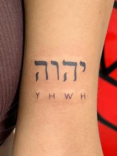 the word hwhy written in hebrew on someone's left arm with black ink